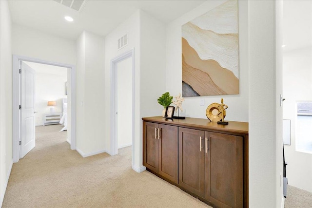 hallway featuring light colored carpet