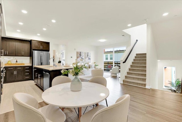 dining area featuring sink and light hardwood / wood-style flooring