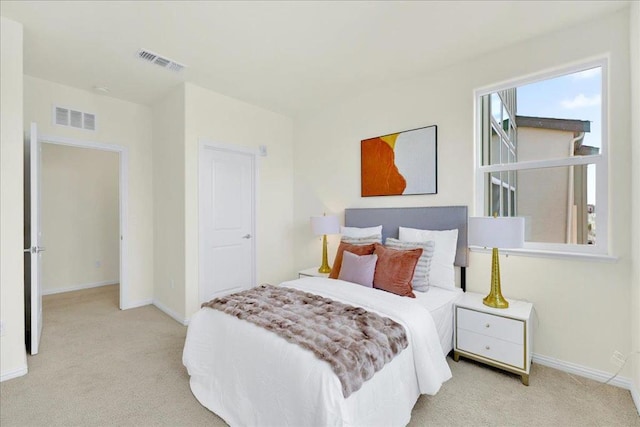 bedroom with light colored carpet