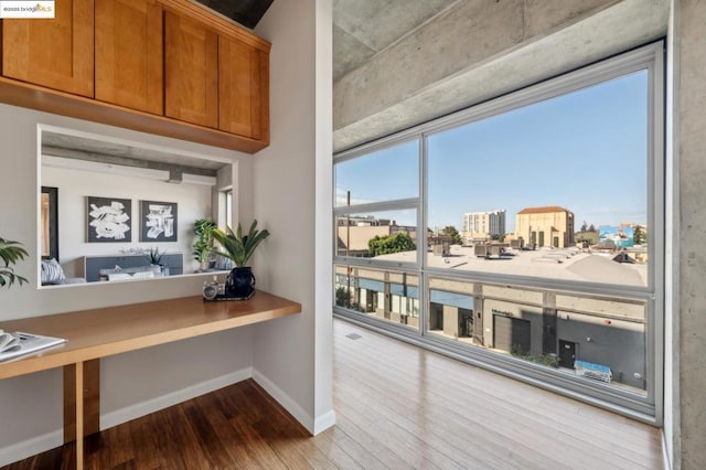 interior space with hardwood / wood-style flooring and built in desk