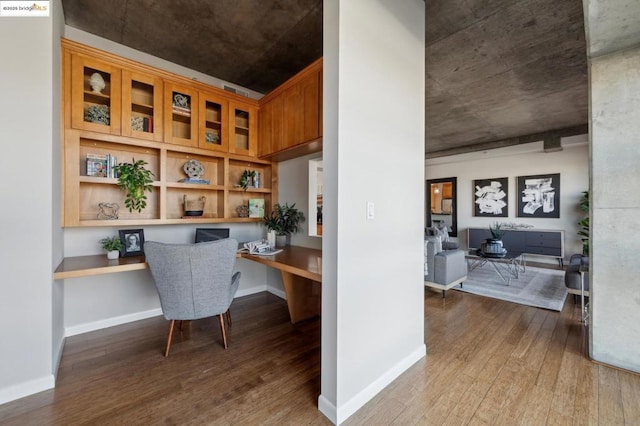 office area with built in desk and wood-type flooring