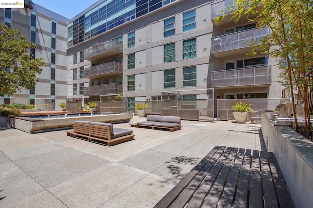 view of home's community with an outdoor kitchen and a patio area