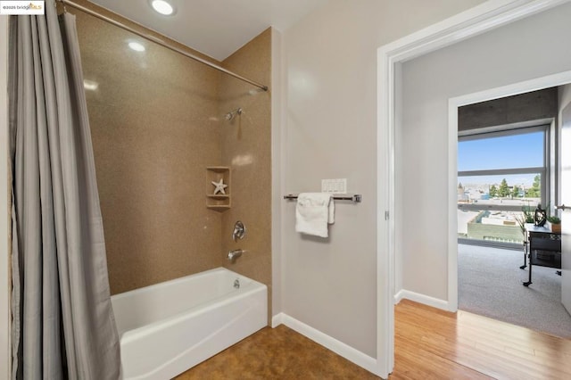 bathroom with wood-type flooring and shower / bath combo