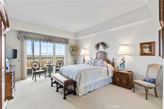 bedroom featuring access to outside and light colored carpet