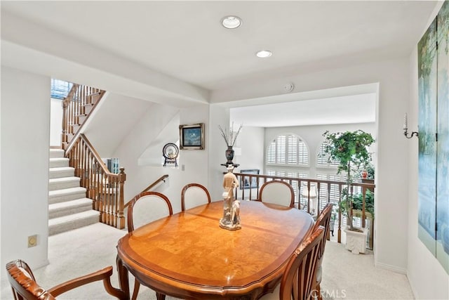 dining space featuring light colored carpet