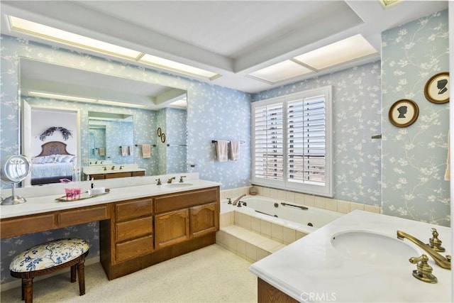 bathroom featuring vanity and tiled bath