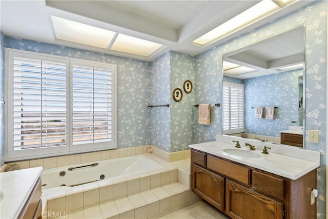 bathroom with a relaxing tiled tub and vanity