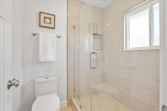 bathroom featuring an enclosed shower and toilet