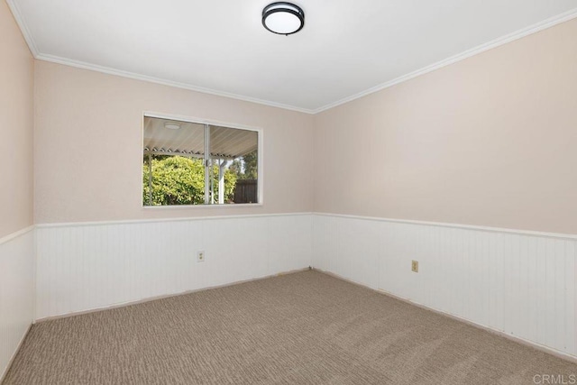 empty room with ornamental molding and carpet flooring