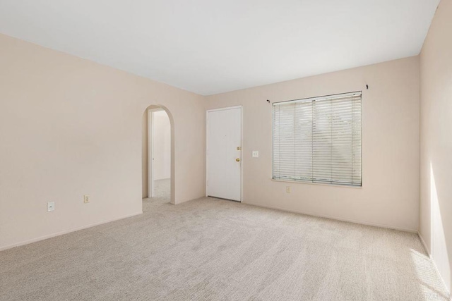 unfurnished room with light colored carpet