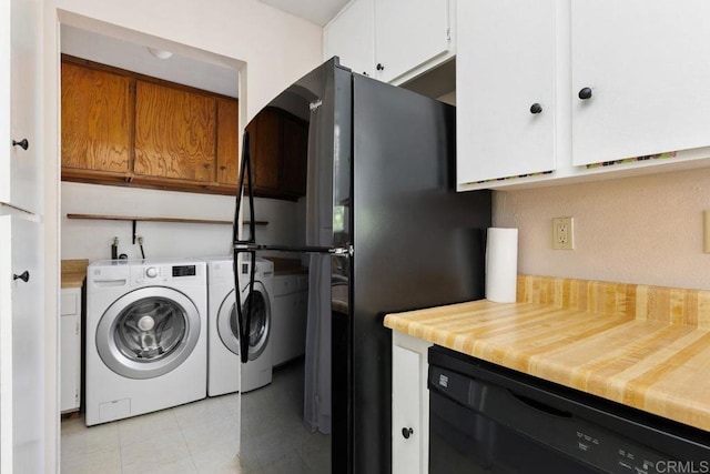 washroom featuring cabinets, washer and clothes dryer, and light tile patterned floors