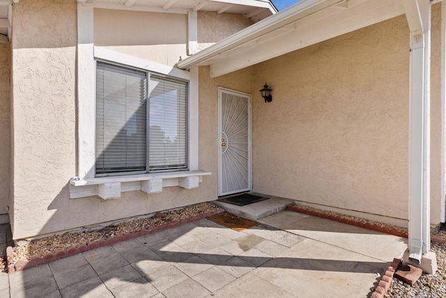 entrance to property featuring a patio