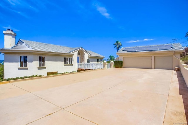 ranch-style house featuring solar panels