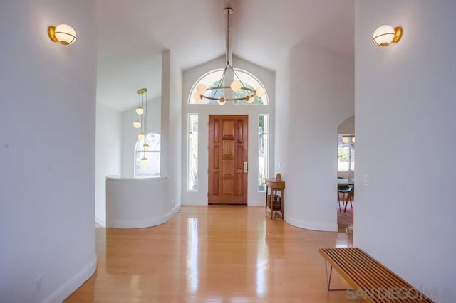 entryway featuring lofted ceiling with beams and light hardwood / wood-style floors