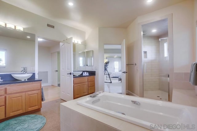 bathroom with vanity, plus walk in shower, and plenty of natural light