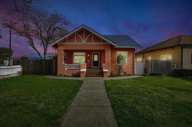 view of front of house featuring a porch and a lawn