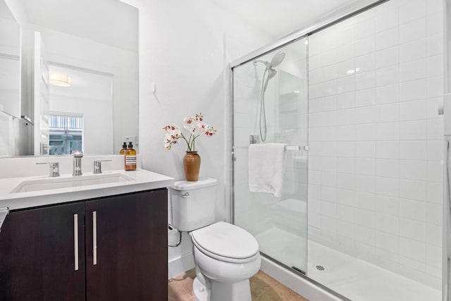 bathroom featuring vanity, tile patterned floors, toilet, and walk in shower