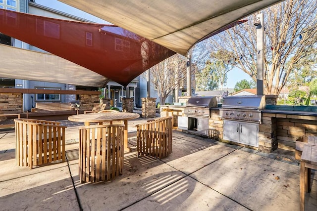 view of patio with area for grilling and exterior kitchen