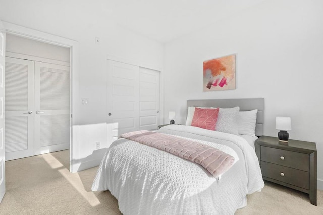 carpeted bedroom featuring two closets