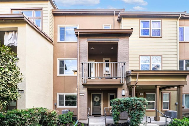 exterior space with a balcony and central AC unit