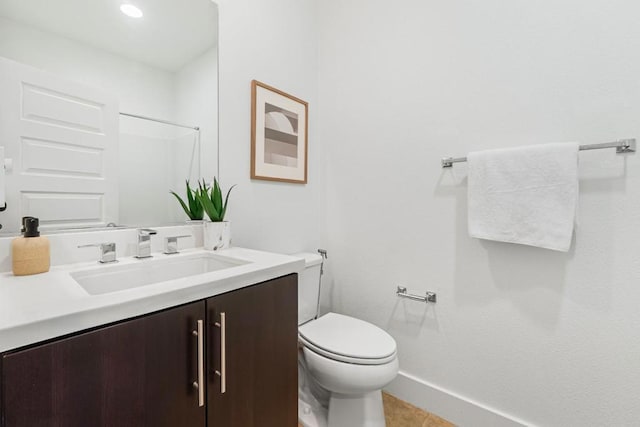 bathroom with tile patterned flooring, vanity, and toilet