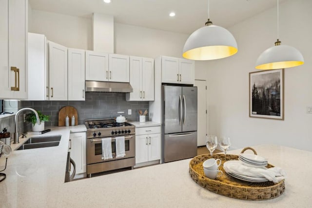 kitchen with white cabinetry, appliances with stainless steel finishes, sink, and decorative light fixtures