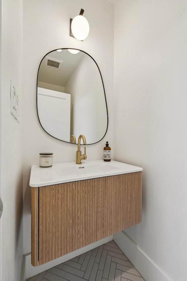 bathroom with parquet flooring and vanity