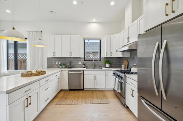 kitchen with white cabinetry, appliances with stainless steel finishes, and hanging light fixtures