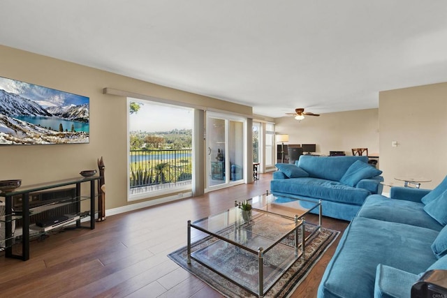 living room with dark hardwood / wood-style floors and ceiling fan