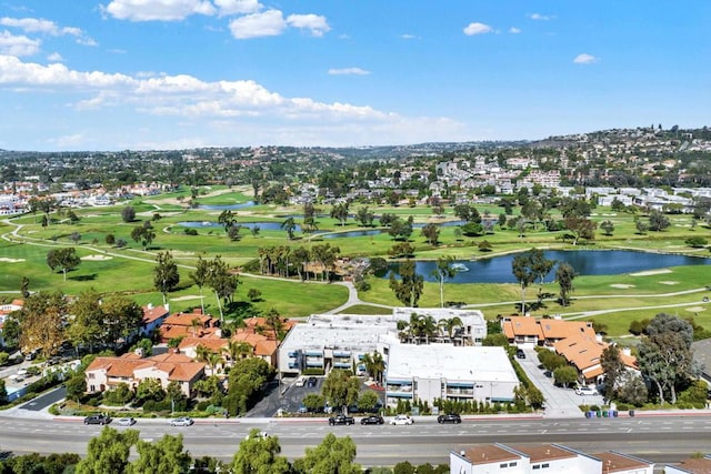 birds eye view of property featuring a water view and view of golf course