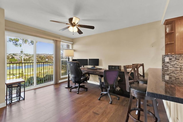 office area featuring dark wood-style flooring, baseboards, and a ceiling fan