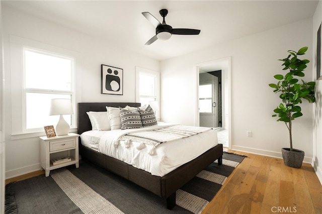 bedroom with ceiling fan and light hardwood / wood-style floors