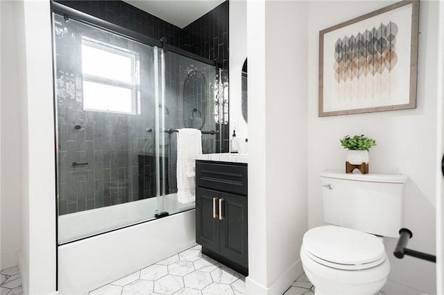 full bathroom featuring enclosed tub / shower combo, vanity, and toilet