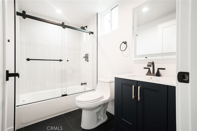 full bathroom featuring enclosed tub / shower combo, vanity, toilet, and tile patterned flooring