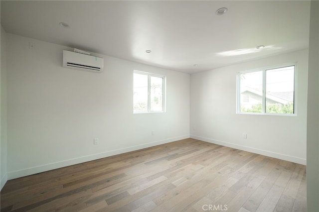 empty room with wood-type flooring and a wall mounted AC