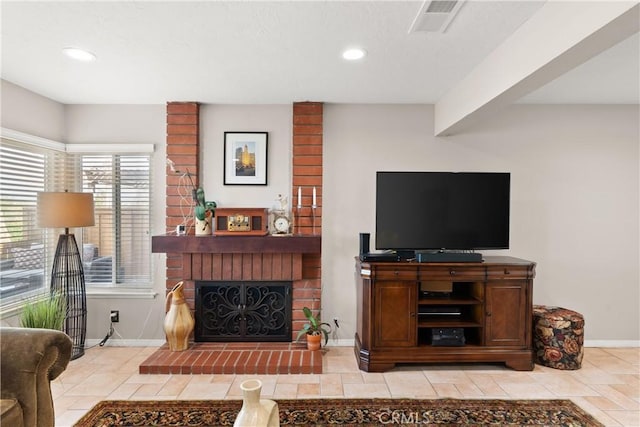 living room with a brick fireplace