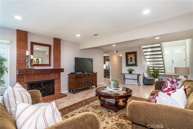 living room with a brick fireplace