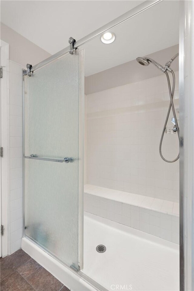 bathroom featuring a shower with shower door