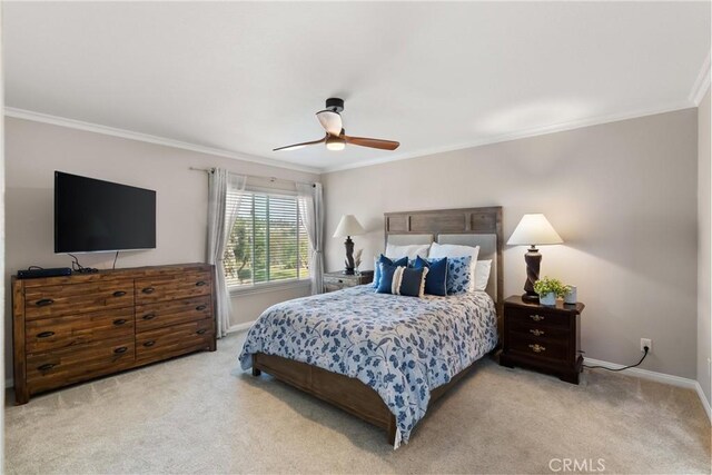 bedroom featuring crown molding, light carpet, and ceiling fan