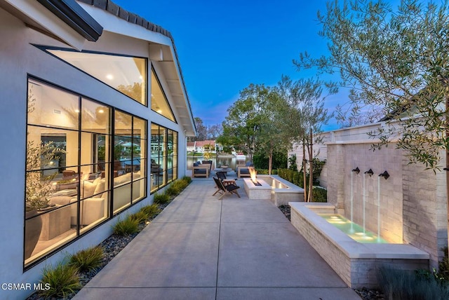 view of patio featuring an outdoor fire pit