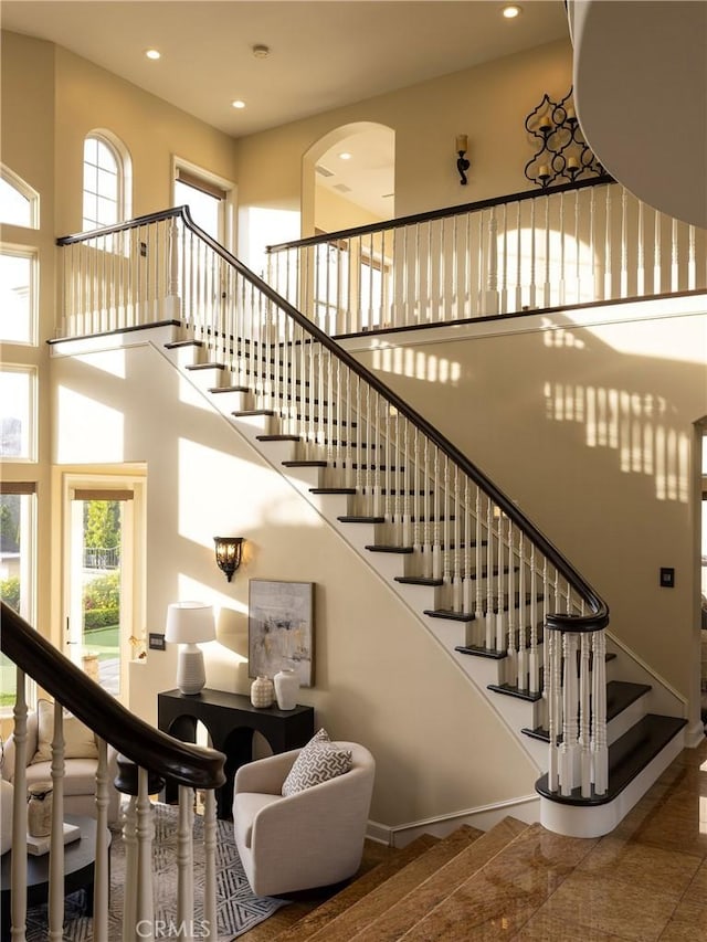 staircase featuring a high ceiling