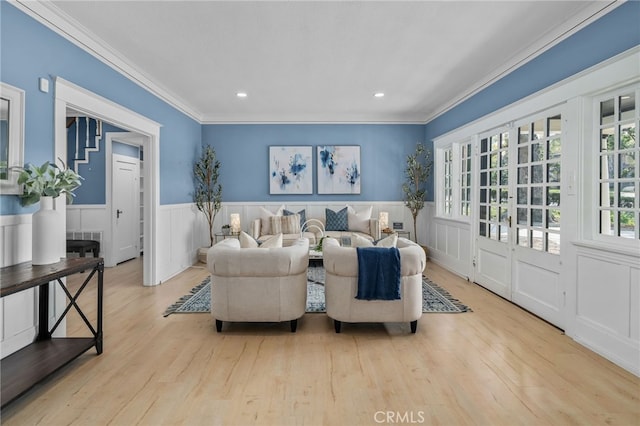 living room featuring crown molding and light hardwood / wood-style floors