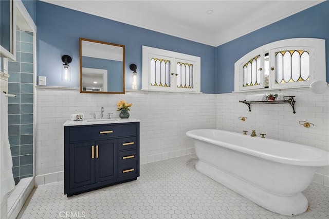 bathroom featuring a washtub, vanity, and tile walls