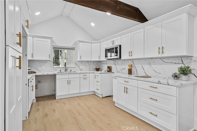 kitchen featuring lofted ceiling, sink, white cabinets, and light hardwood / wood-style flooring