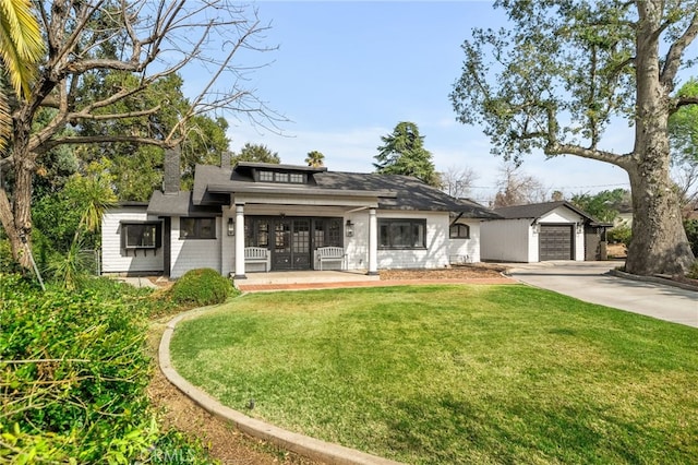 view of front of home featuring a garage, a porch, and a front yard