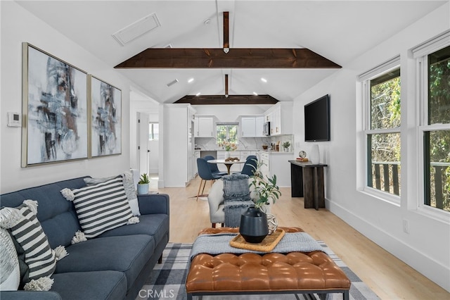 living room featuring light hardwood / wood-style floors and lofted ceiling with beams