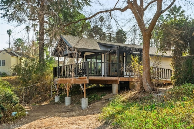 back of house with a wooden deck