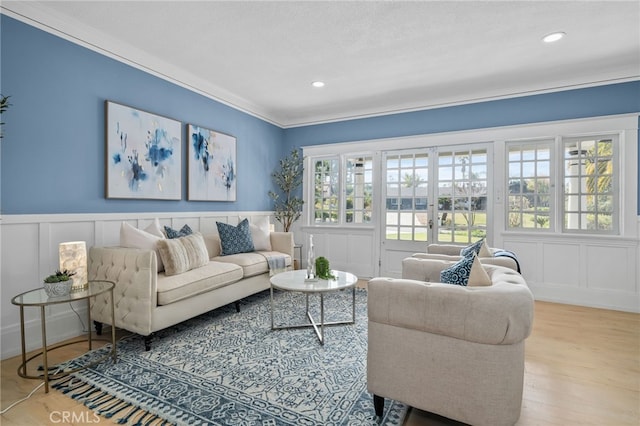 living room with french doors, ornamental molding, and hardwood / wood-style floors