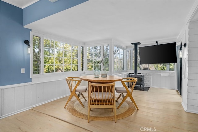 sunroom / solarium featuring a wood stove