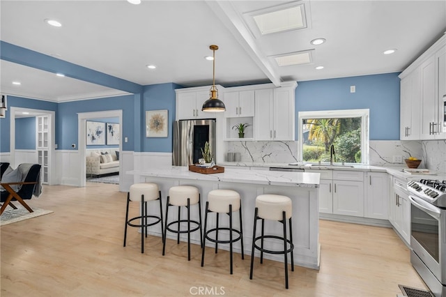 kitchen featuring stainless steel appliances, a center island, and white cabinets